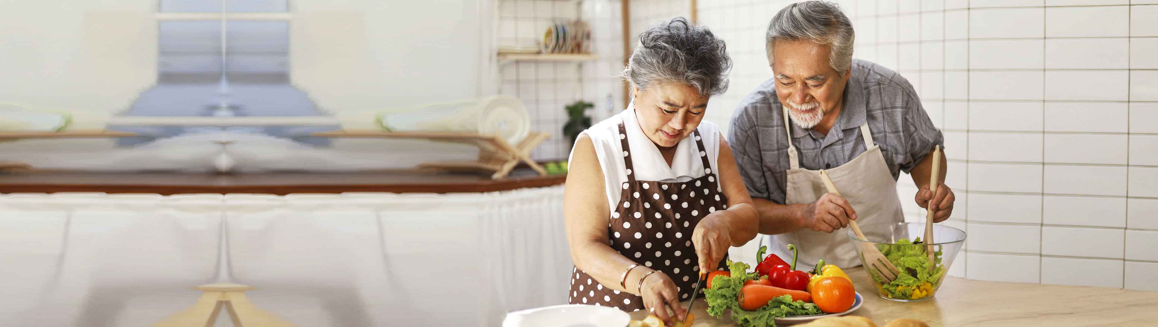 A men and a women preparing healthy salad
